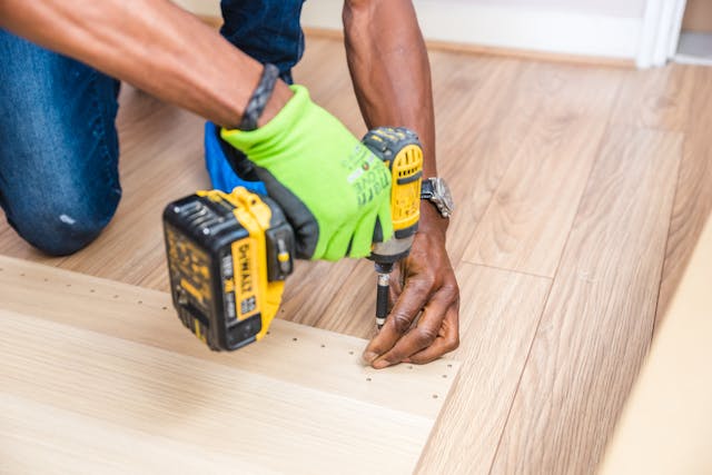 person%20in%20a%20green%20work%20glove%20using%20a%20drill person%20in%20a%20green%20work%20glove%20using%20a%20drill